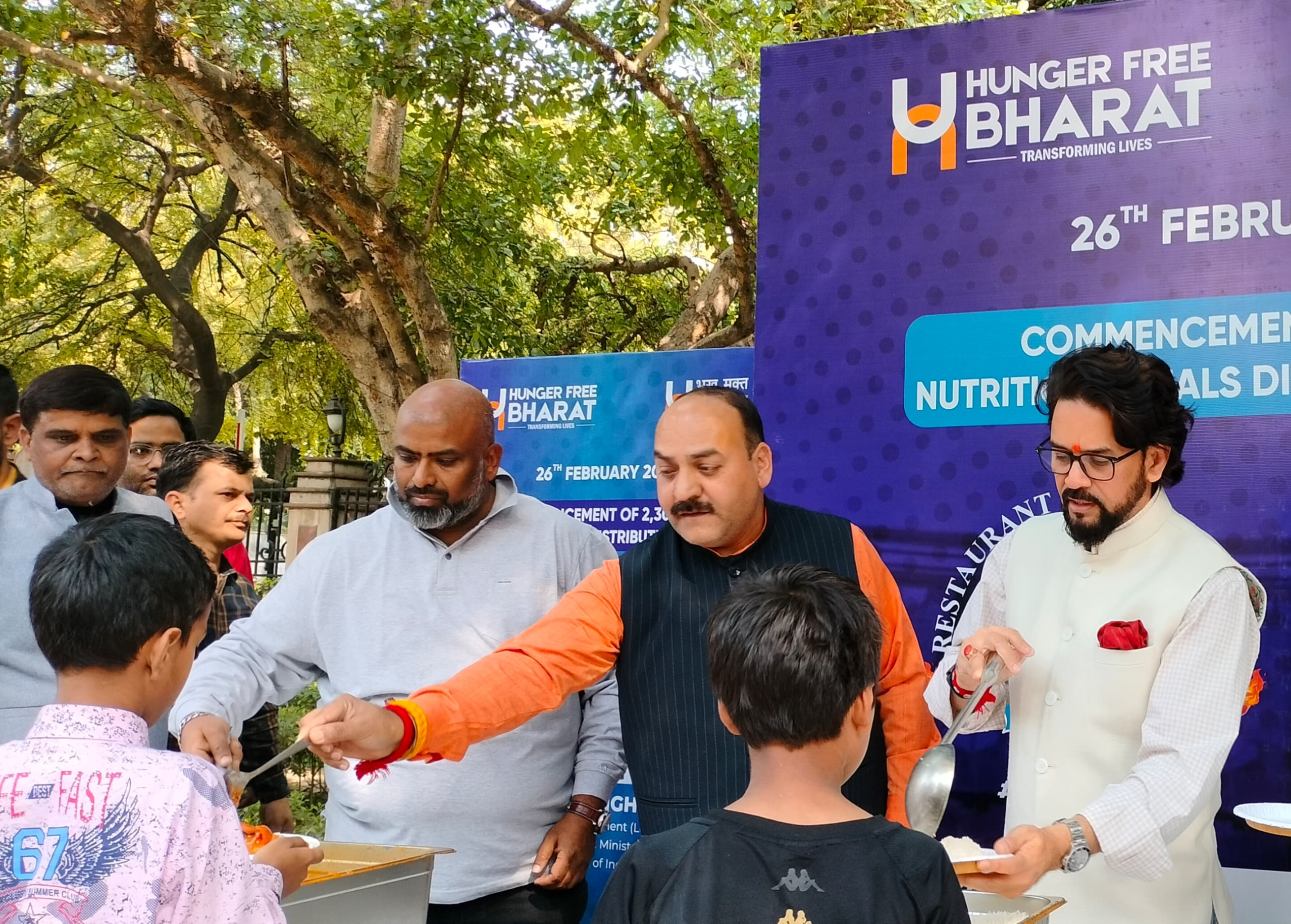 Meal distribution drive on a Delhi street — volunteers, queue, warmth
